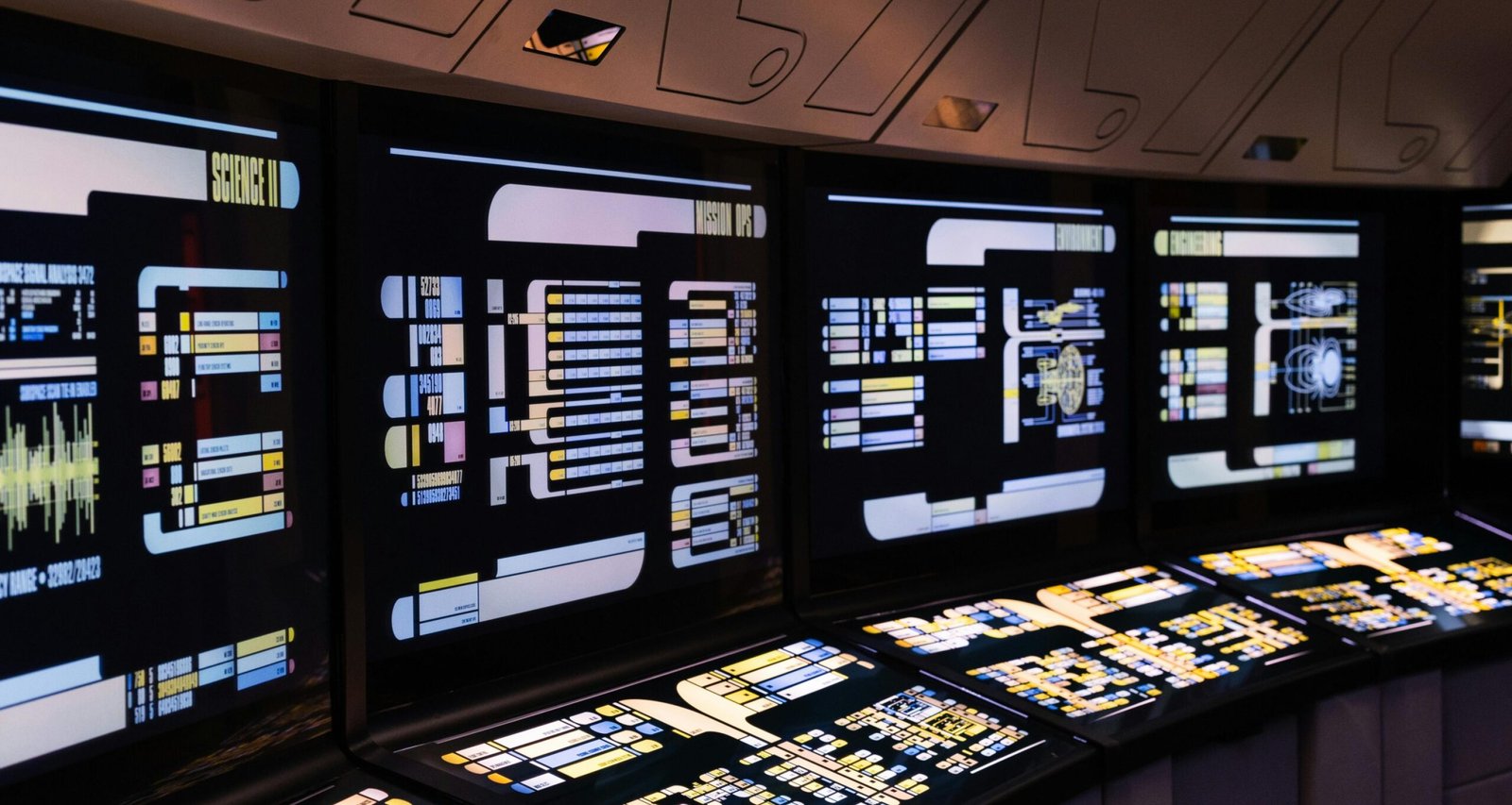 A high-tech command center with illuminated digital screens in a futuristic setting.